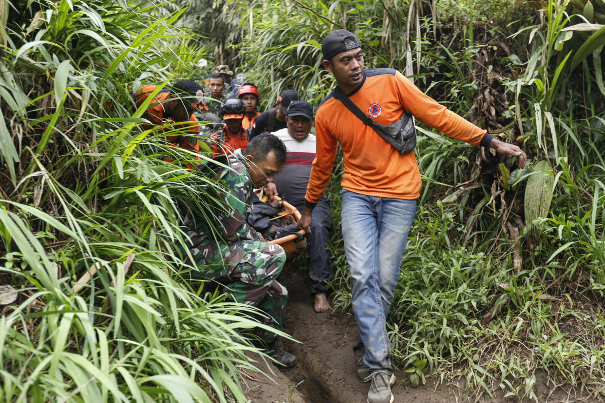 Rescuers carry away a victim after the eruption of Mount Marapi in West Sumatra, Indonesia. 