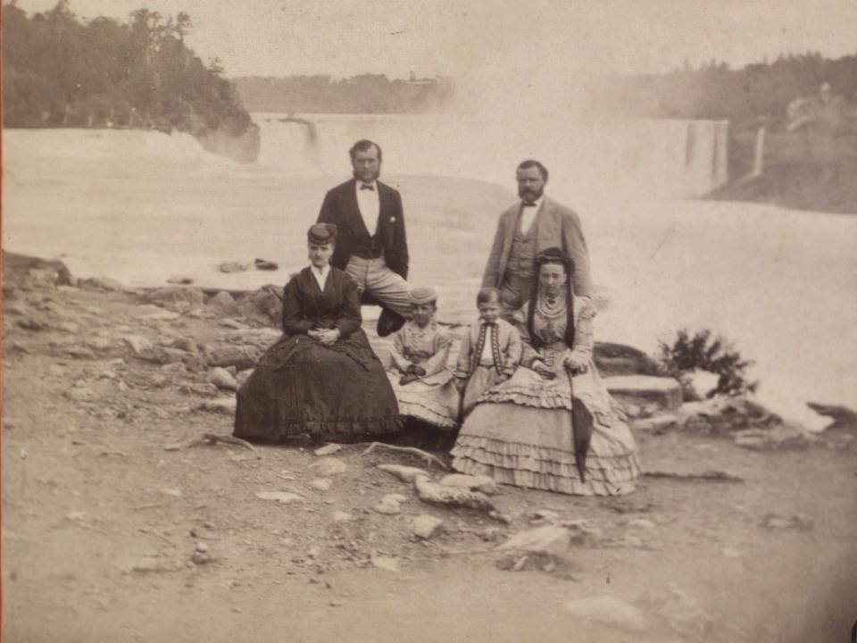 Tourists pose for a phot in front of Niagara Falls in 1870.