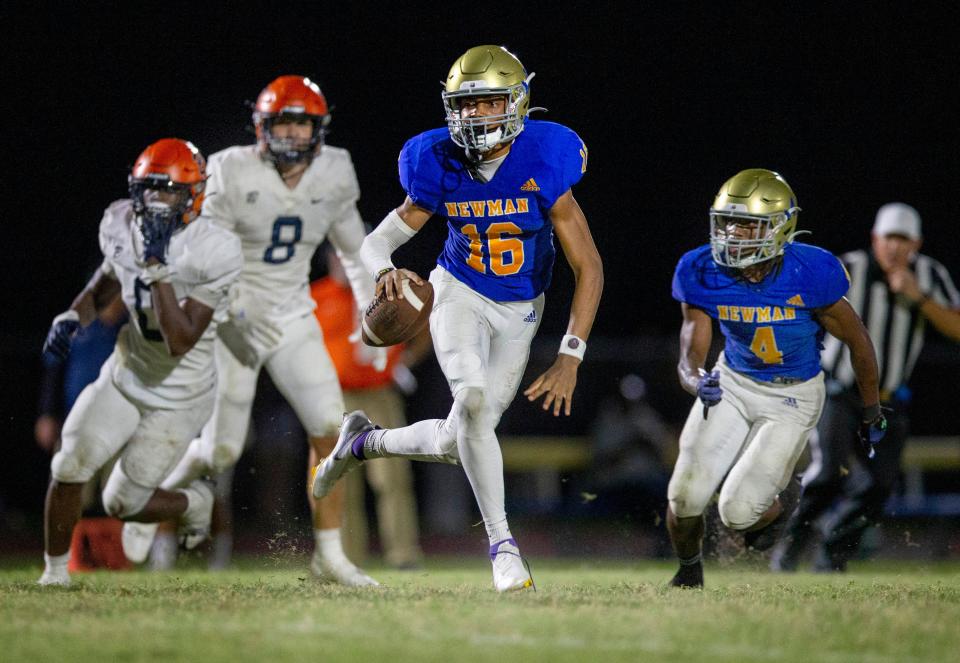 Cardinal Newman quarterback Jyron Hughley rolls out of the pocket against Benjamin during their football game on October 20, 2023 in West Palm Beach, Florida.