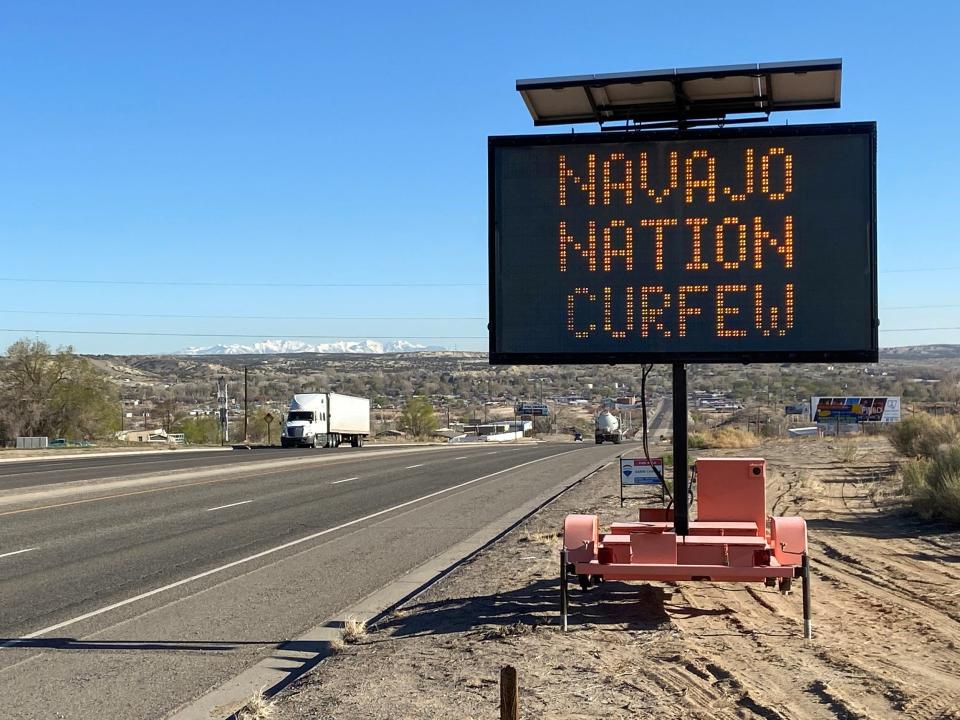 A road sign outside Bloomfield warns Navajos to stay home during their nation's 8pm to 5am curfew to slow the spread of the coronavirus disease (COVID 19), New Mexico, in April 2020.JPG