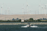 A boat approaches the temporary emergency drought barrier built by the California Department of Water Resources on West False River near Oakley Calif., on Monday, July 21, 2022. Plans to remove the barrier last fall were scrapped due to dry conditions. It protects against saltwater getting into the state’s water supply. (AP Photo/Rich Pedroncelli)