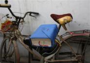 REFILE - CORRECTING SLUG A bible is placed on a bicycle saddle at an underground Catholic church in Tianjin November 10, 2013. Picture taken November 10, 2013. REUTERS/Kim Kyung-Hoon