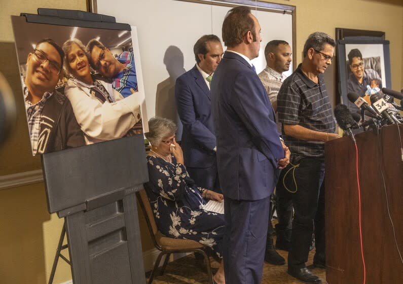 CORONA, CA-AUGUST 26, 2019: Russell French, right, addresses the media during a press conference at the Ayres Hotel in Corona to announce plans to file a civil claim against the city of Los Angeles and LAPD officer Salvador Sanchez for the shooting death of his son Kenneth French inside a Corona Costco earlier this year. At left is his wife Paola French, 2nd from right is his son Kevin French. 2nd from left is attorney Eric Valenzuela and 3rd from left is attorney Dale Galipo. Photograph at left is left to right-Kenneth French and his parents, Paola, and Russell, taken in 2019. Photograph at right is Kenneth French holding his cousin Lily DÕCunha, taken in 2014. (Mel Melcon/Los Angeles Times)