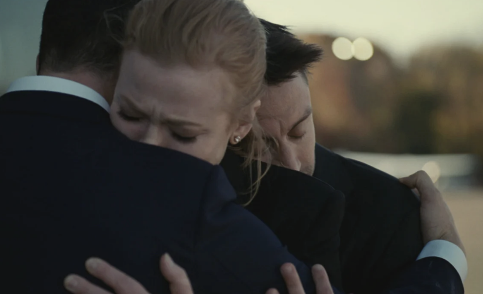 Sarah Snook as Shiv hugging Jeremy Strong (Kendall) and Kieran Culkin (Roman) after learning their father had died in Season 4 of 