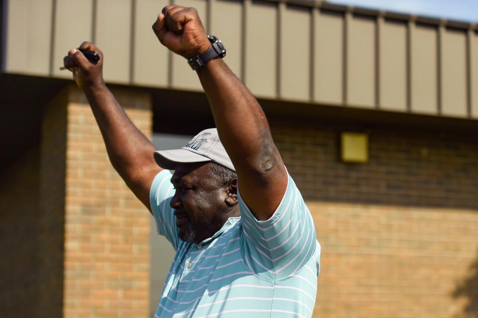 Henry Thomas throws his hands up in celebration after passing his drivers license at the Saluda Dam Road Department of Motor Vehicles office in Berea on Thursday, May 25, 2025. Thomas hasn't driven by himself in 25 years.