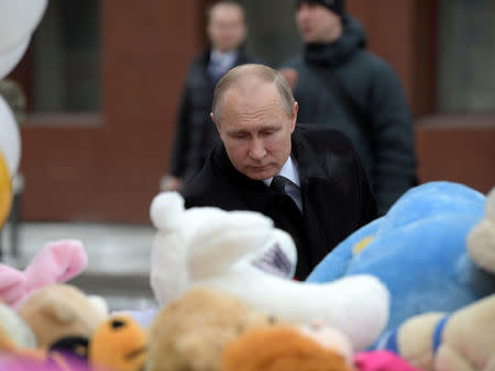 Russian President Vladimir Putin visits the site of fire, that killed at least 64 people at a busy shopping mall, in Kemerovo, Russia March 27, 2018. Sputnik/Alexei Druzhinin/Kremlin via REUTERS