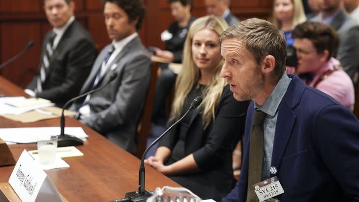 Man in a suit speaking to Congress