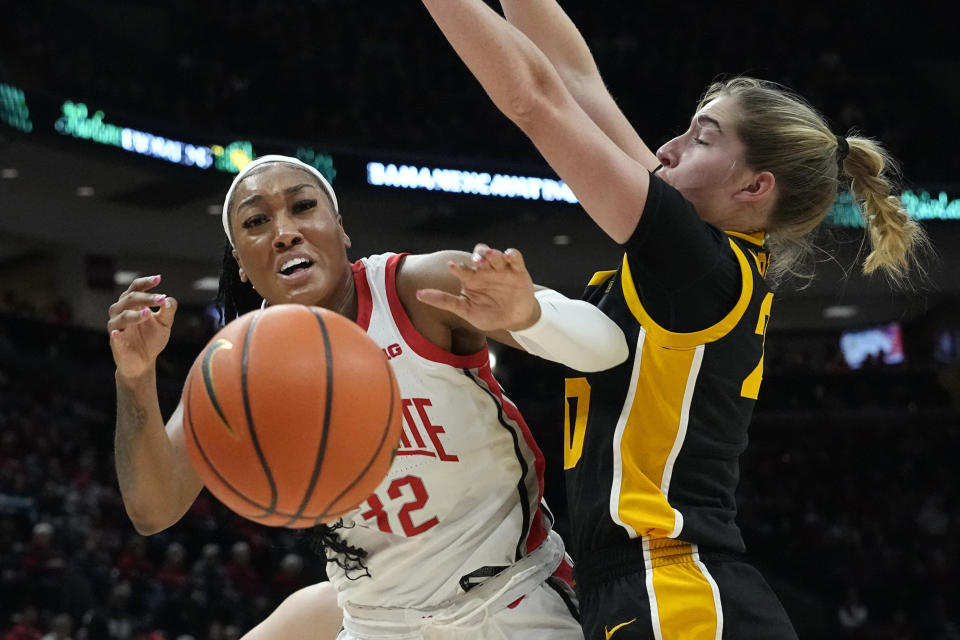 Iowa guard Kate Martin, right, knocks the ball away from Ohio State forward Cotie McMahon, left, in the first half of an NCAA college basketball game Sunday, Jan. 21, 2024, in Columbus, Ohio. (AP Photo/Sue Ogrocki)