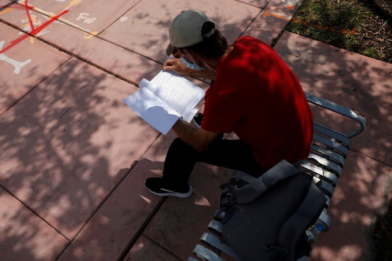 A man reads an unemployment form, as the outbreak of coronavirus disease (COVID-19) continues, in Miami Beach