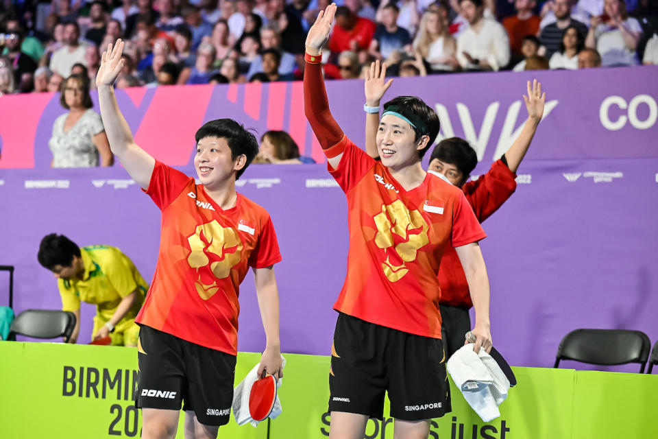 Singapore paddlers Zeng Jian (left) and Feng Tianwei acknowledge the crowd after winning the women's doubles gold at the 2022 Commonwealth Games in Birmingham. (PHOTO: Commonwealth Games Singapore/ Andy Chua)