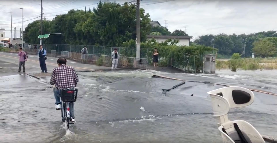 <p>A man cycles on a flooded road damaged after an earthquake hit Osaka, Japan June 18, 2018, in this still image taken from a video obtained from social media. (Photo: Twitter/@tw_hds/via Reuters) </p>