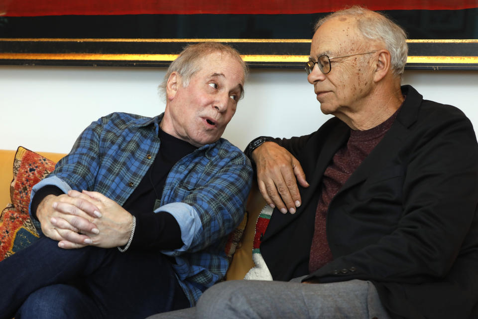 This Nov. 8, 2019 photo shows singer-songwriter, Paul Simon, left, and author-philosopher Peter Singer during an interview in New York to promote the new edition of Singer's book “The Life You Can Save." (AP Photo/Richard Drew)