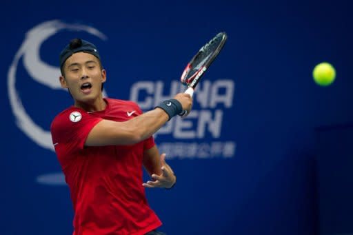 Ze Zhang of China hits a return to Richard Gasquet of France during their men's singles tennis match of the China Open tennis tournament at the National Tennis Center of Beijing. Zhang won 6-4, 3-6, 6-4