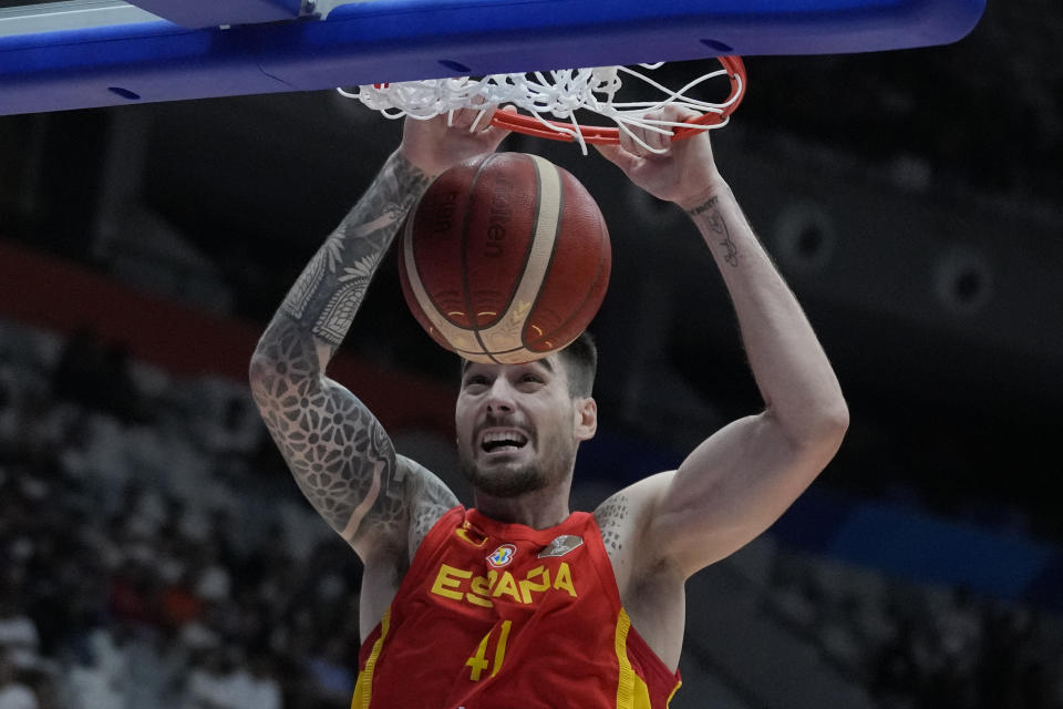 Spain forward Juancho Hernangomez (41) dunks to score against Iran during the Basketball World Cup group G match between Spain and Iran at the Indonesia Arena stadium in Jakarta, Indonesia, Wednesday, Aug. 30, 2023. (AP Photo/Dita Alangkara)