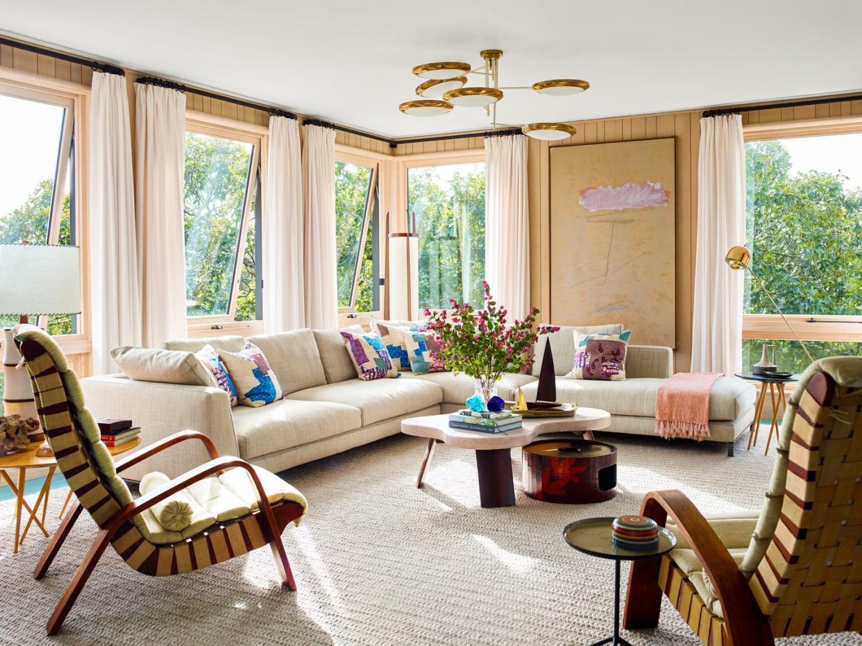 a living room with a chandelier and couches