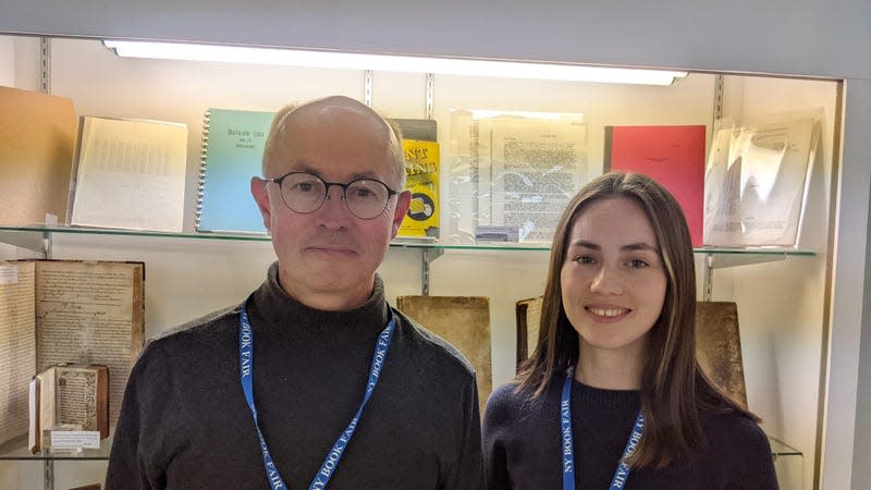 Christian White and his Daughter Poppy in front of their collection of documents relating to AI.