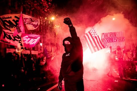 A demonstrator raises a fist while protesting during a national strike in Paris, France - Credit: Christophe Morin&nbsp;/Bloomberg