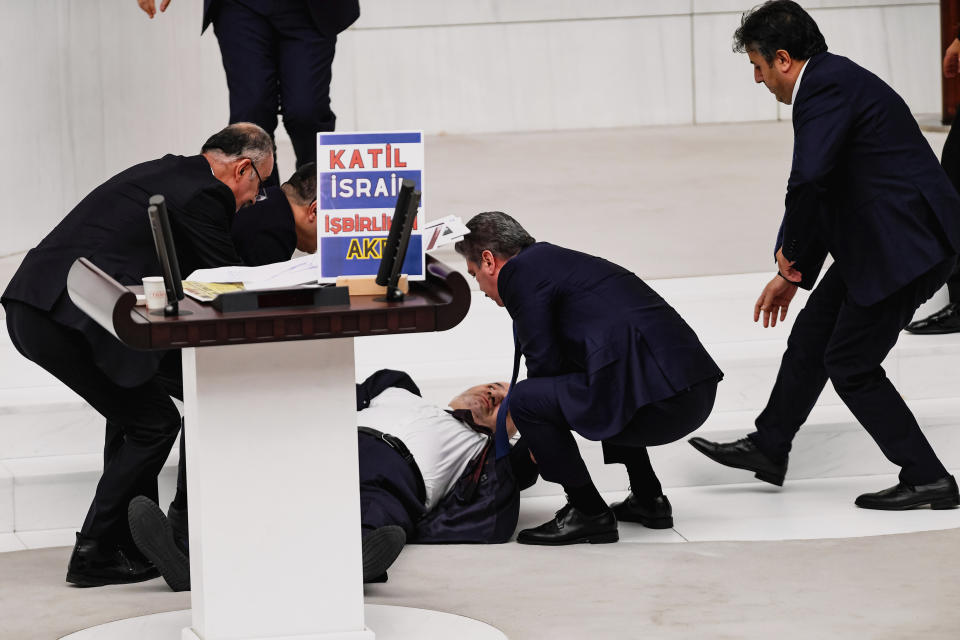 Hasan Bitmez, 53, center, a Turkish lawmaker from the Islamist Saadet Partisi, or Felicity Party, collapses after speaking at the main chamber of the Turkish parliament in Ankara, Thursday, Dec.14, 2023. Bitmez died in a hospital on Thursday, days after he suffered a heart attack, and collapsed in parliament just after delivering a speech critical of Israel and of the ruling party's relationship with the country. (Selahattin Sonmez/Dia Images via AP)