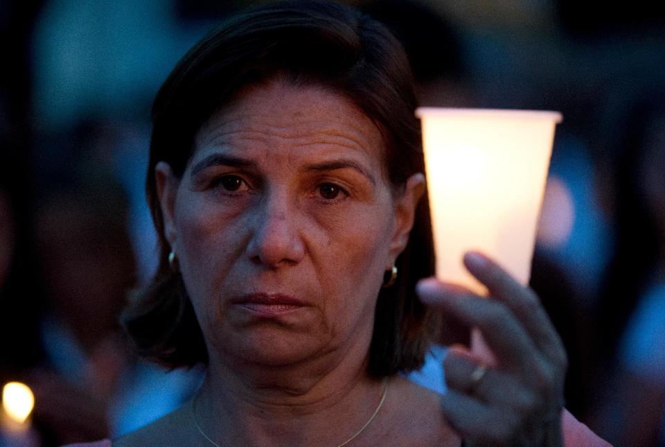 A demonstrator holds candle during a protest against the violence, in Caracas, Venezuela, Friday, March 7, 2014. Venezuela is coming under increasing international scrutiny amid violence that most recently killed a National Guardsman and a civilian. United Nations human rights experts demanded answers Thursday from Venezuela's government about the use of violence and imprisonment in a crackdown on widespread demonstrations. (AP Photo/Fernando Llano)