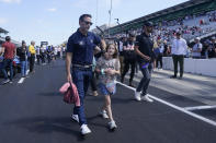 Jimmie Johnson walks with his daughter following the drivers meeting for the Indianapolis 500 auto race at Indianapolis Motor Speedway, Saturday, May 28, 2022, in Indianapolis. (AP Photo/Darron Cummings)