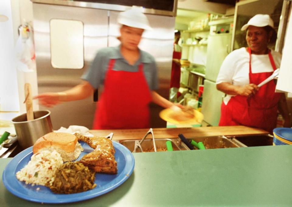 Cook Emma Lindsay, right, and assistant Denise Gonsalves put the finishing touches on the lunch entrees at Anntony’s Carribean restaurant in Brevard court in this April 27, 2000 file photo.