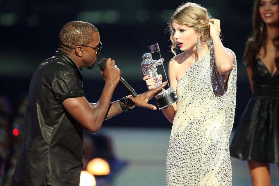 Kanye West jumps onstage after Taylor Swift wins the 'Best Female Video' award during the 2009 MTV Video Music Awards (Getty Images)