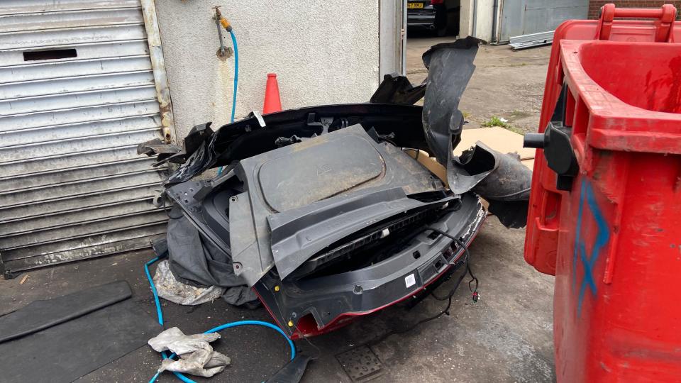 A pile of broken car parts on the ground