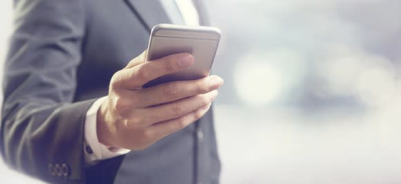 A businessman looking at his smartphone