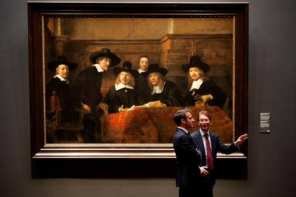 French President Emmanuel Macron and museum director Taco Dibbits talk as they visit the Rijksmuseum, in Amsterdam, Netherlands, on April 12, 2023. 
