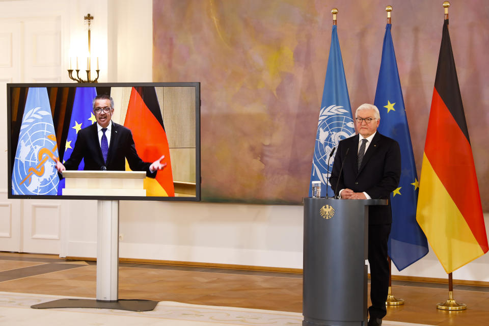 German President Frank-Walter Steinmeier, right, and Director General of the World Health Organization Tedros Adhanom Ghebreyesus, left on the screen, brief the media on a virtual joint news conference at Bellevue Palace in Berlin, Germany, Monday, Feb. 22, 2021. (AP Photo/Markus Schreiber)