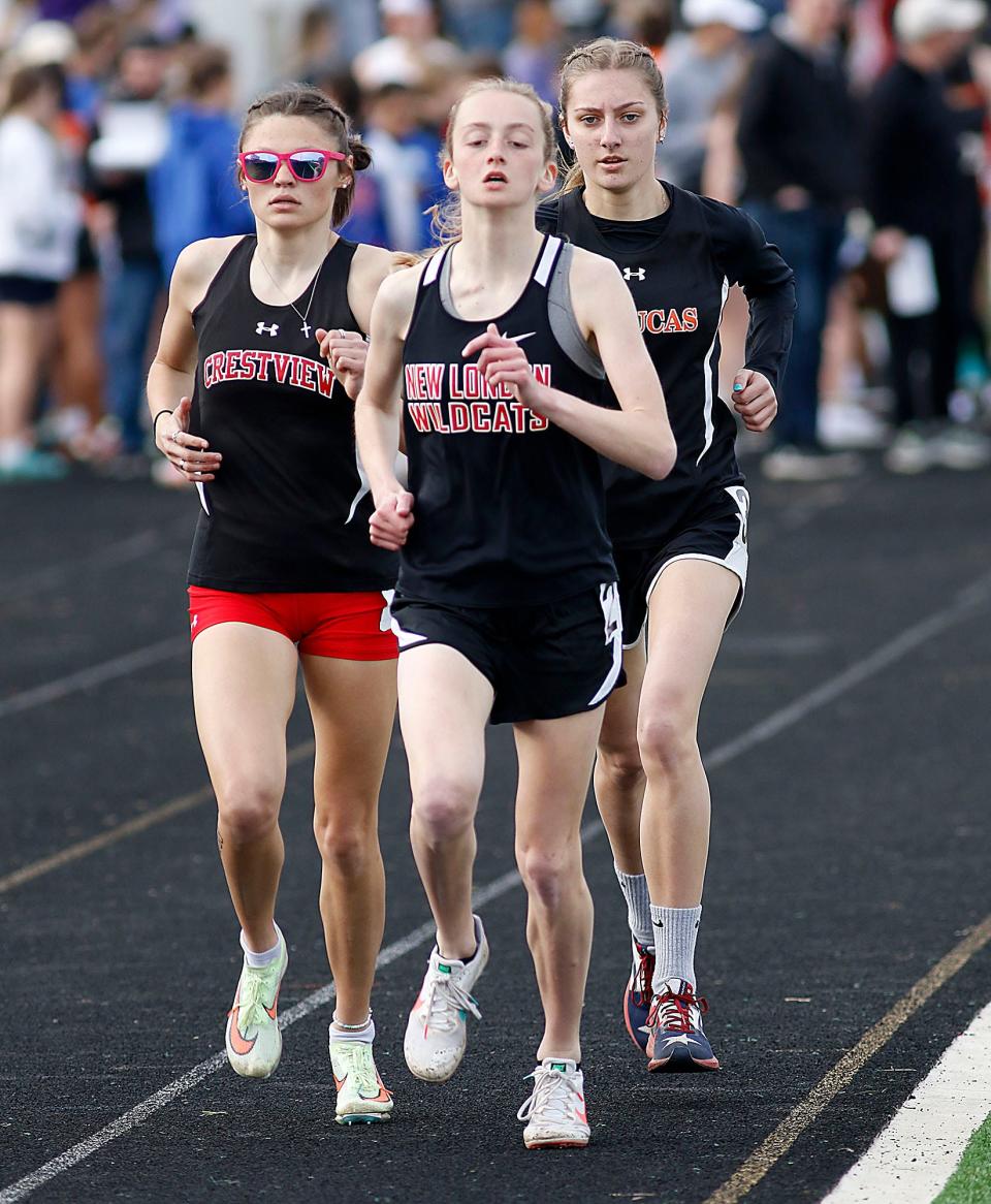 Crestview's Morgan Welch, New London's Reese Landis and Lucas' Chloe Sturts compete in the 1600 meter run during the Forest Pruner Track Invitational at Crestview High School on Friday, April 22, 2022. TOM E. PUSKAR/TIMES-GAZETTE.COM