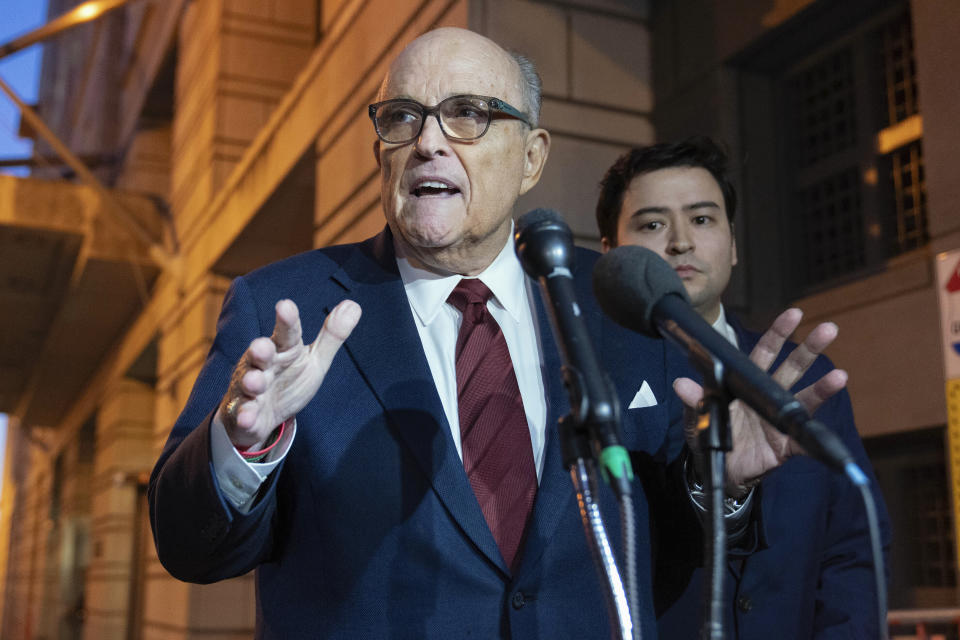 Former New York Mayor Rudy Giuliani talks to reporters as he leaves the federal courthouse in Washington, Monday, Dec. 11, 2023. The trial will determine how much Giuliani will have to pay two Georgia election workers who he falsely accused of fraud while pushing President Donald Trump's baseless claims after he lost the 2020 election. (AP Photo/Jose Luis Magana)