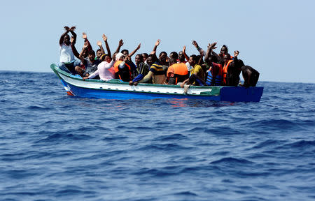 FILE PHOTO: Migrants wait to be rescued by SOS Mediterranee and Doctors Without Borders during a search and rescue operation with the MV Aquarius rescue ship in the Mediterranean off the Libyan Coast, August 10, 2018. REUTERS/Guglielmo Mangiapane/File Photo