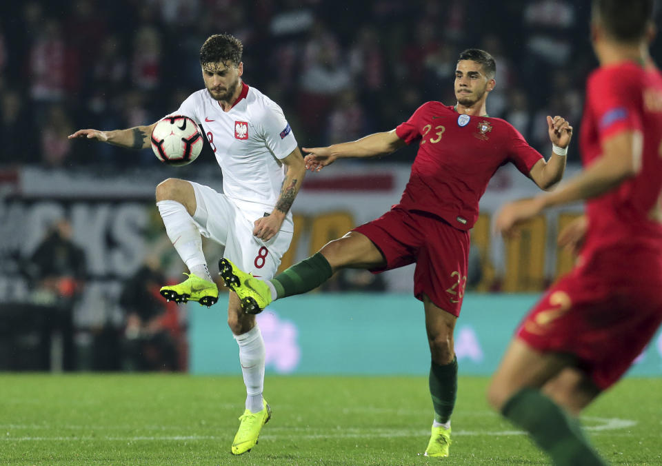 Portugal's Andre Silva vies for the ball with Poland's Mateusz Klich, left, during the UEFA Nations League soccer match between Portugal and Poland at the D. Afonso Henriques stadium in Guimaraes, Portugal, Tuesday, Nov. 20, 2018. (AP Photo/Manuel Araujo)