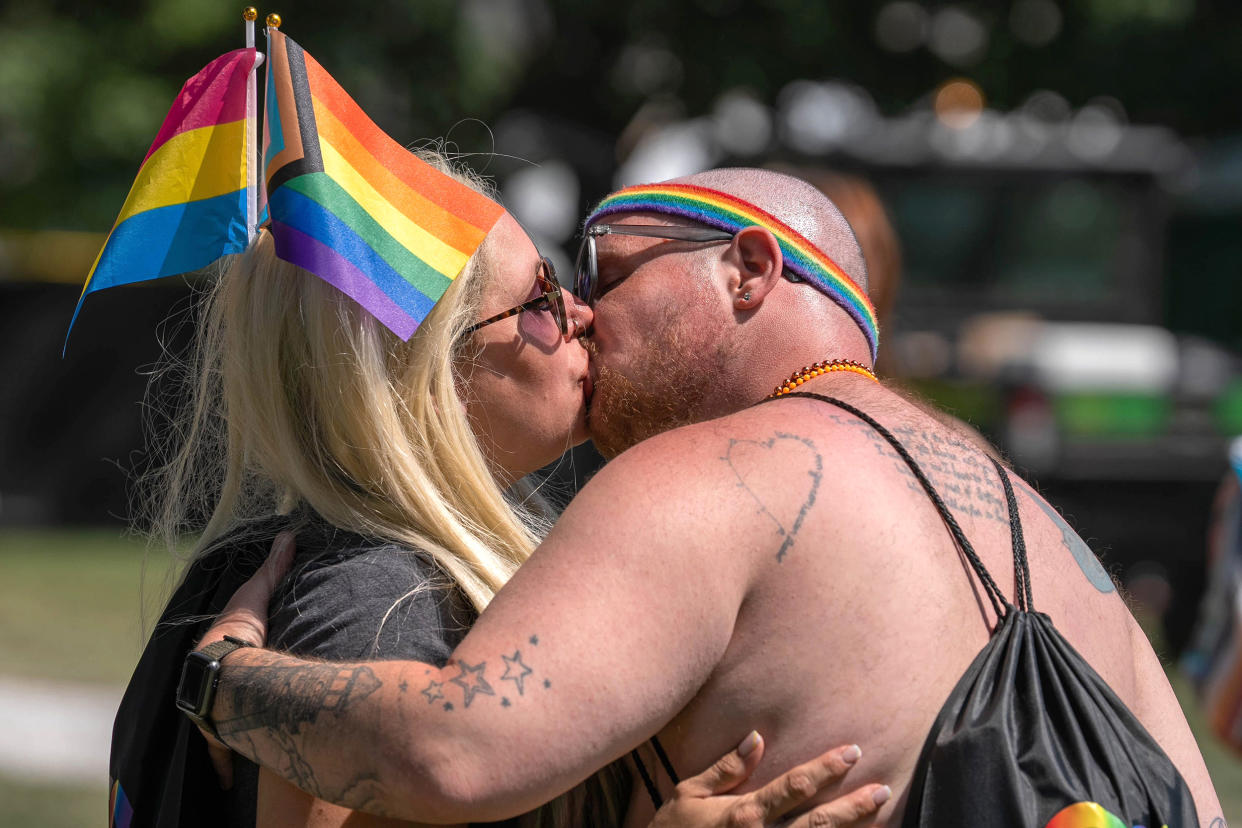 A couple kisses Saturday, June 10, 2023 during the Indy Pride Festival at Military Park in Indianapolis. (Clare Grant / IndyStar / USA TODAY)