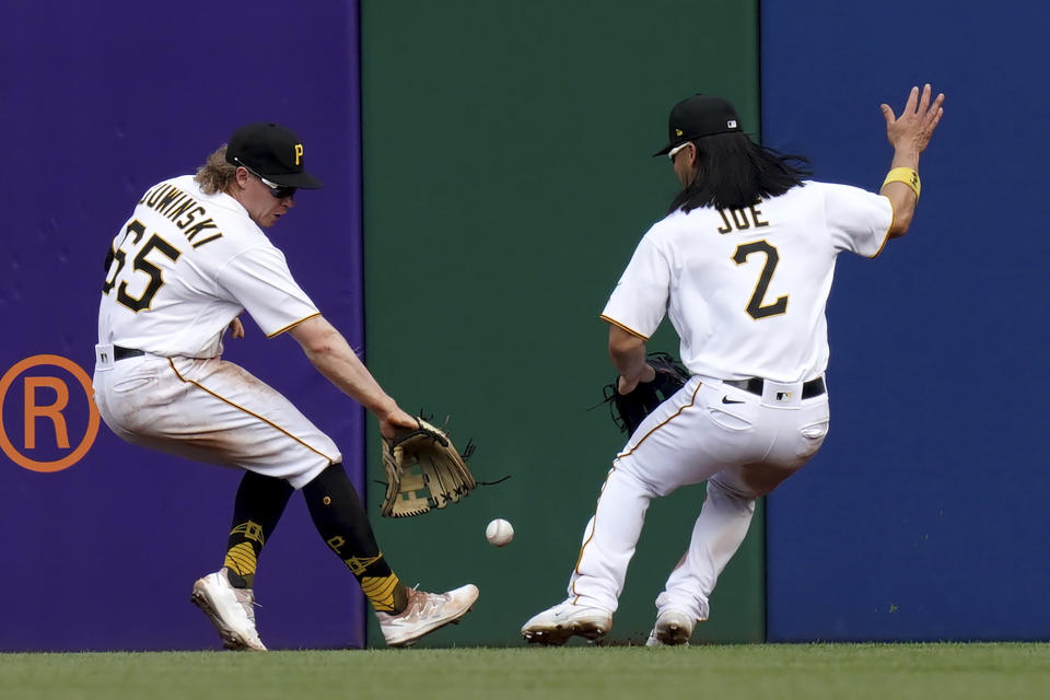 Pittsburgh Pirates center fielder Jack Suwinski reaches for a ball hit by New York Mets' Mark Canha next to right fielder Connor Joe in the seventh inning of a baseball game in Pittsburgh, Saturday, June 10, 2023. (AP Photo/Matt Freed)