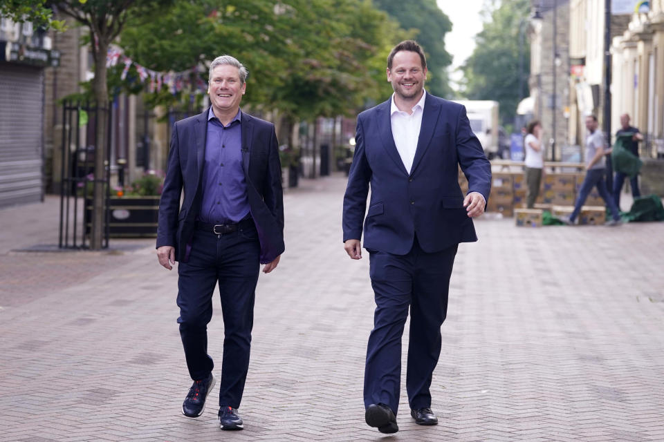 Newly elected lawmaker for Wakefield Simon Lightwood, right, arrives with Labour leader Keir Starmer as Labour reclaimed the West Yorkshire seat from the Conservatives in Wakefield, England, Friday, June 24, 2022. British Prime Minister Boris Johnson suffered a double blow as voters rejected his Conservative Party in two special elections dominated by questions about his leadership and ethics. The centrist Liberal Democrats overturned a big Conservative majority to win the rural southwest England seat of Tiverton and Honiton, while the main opposition Labour Party reclaimed Wakefield in northern England from Johnson's Tories. (Danny Lawson/PA via AP)