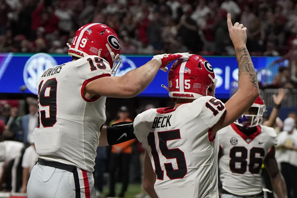 Georgia quarterback Carson Beck (15) celebrates a touchdown during the second half of the Southeastern Conference championship NCAA college football game against Alabama in Atlanta, Saturday, Dec. 2, 2023. (AP Photo/Mike Stewart)