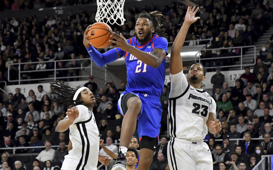 DePaul's Da'Sean Nelson (21) scores as Providence's Bryce Hopkins (23) defends during the first half of an NCAA college basketball game, Saturday, Jan. 21, 2023, in Providence, R.I. (AP Photo/Mark Stockwell)