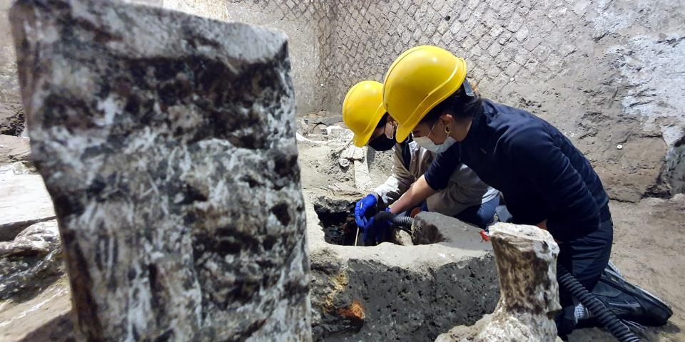 Archaeologists work inside a "slaves room" discovered at a Roman villa near the ancient Roman city of Pompeii, destroyed in 79 AD in volcanic eruption, Italy, 2021.