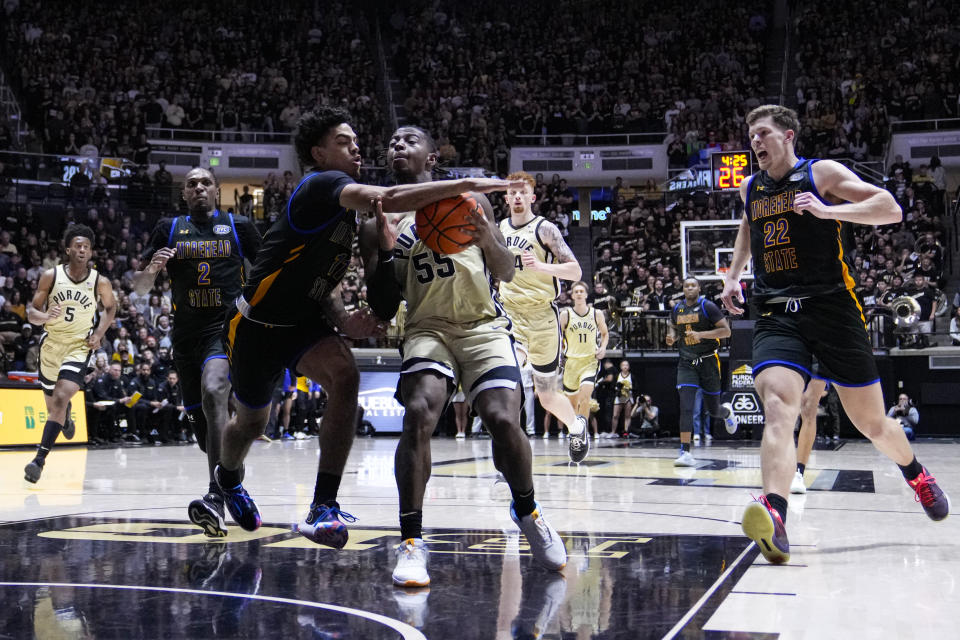 Purdue guard Lance Jones (55) is hit by Morehead State guard Trent Scott (11) during the second half of an NCAA college basketball game in West Lafayette, Ind., Friday, Nov. 10, 2023. (AP Photo/Michael Conroy)