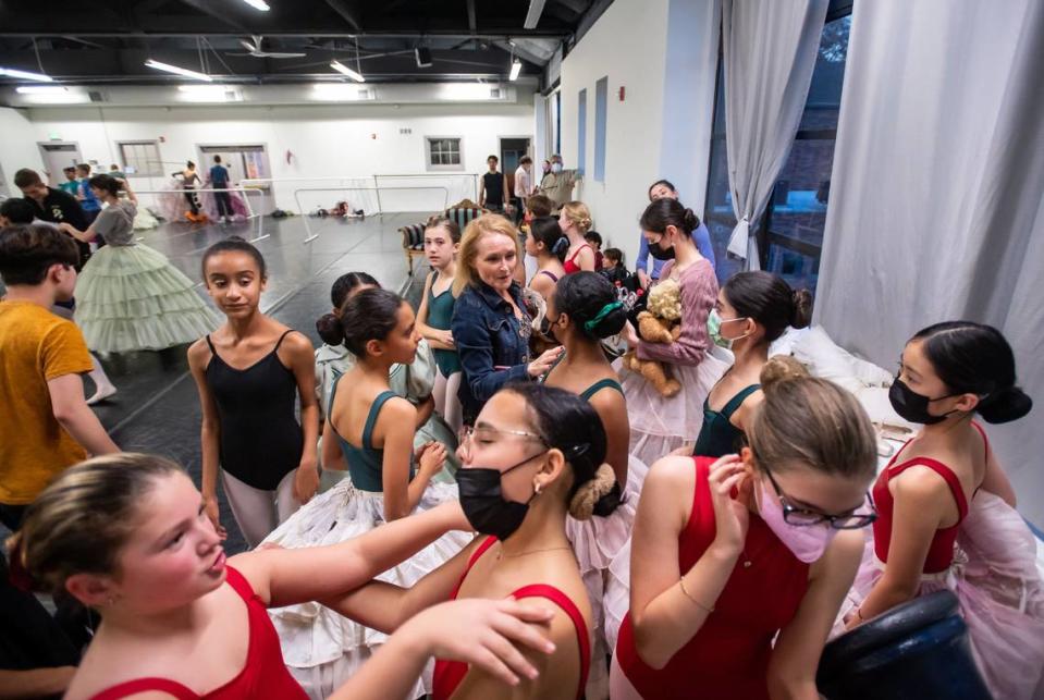 Tiffany Perrodin, center, of West Sacramento, wrangles young ballet dancers as they rehearse Tuesday. About 300 child dancers participate in the show.