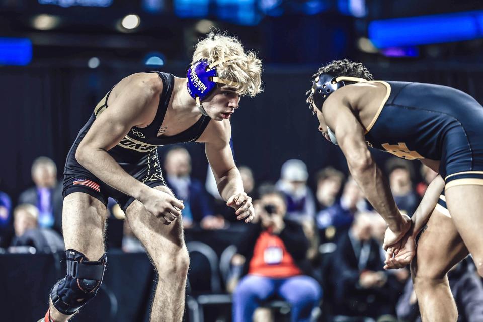 Bronson's Perry Lake sizes up his state finals opponent Shawn McGuire of Iron Mountain on Saturday. Lake took runner-up honors at 126 pounds at the state finals.