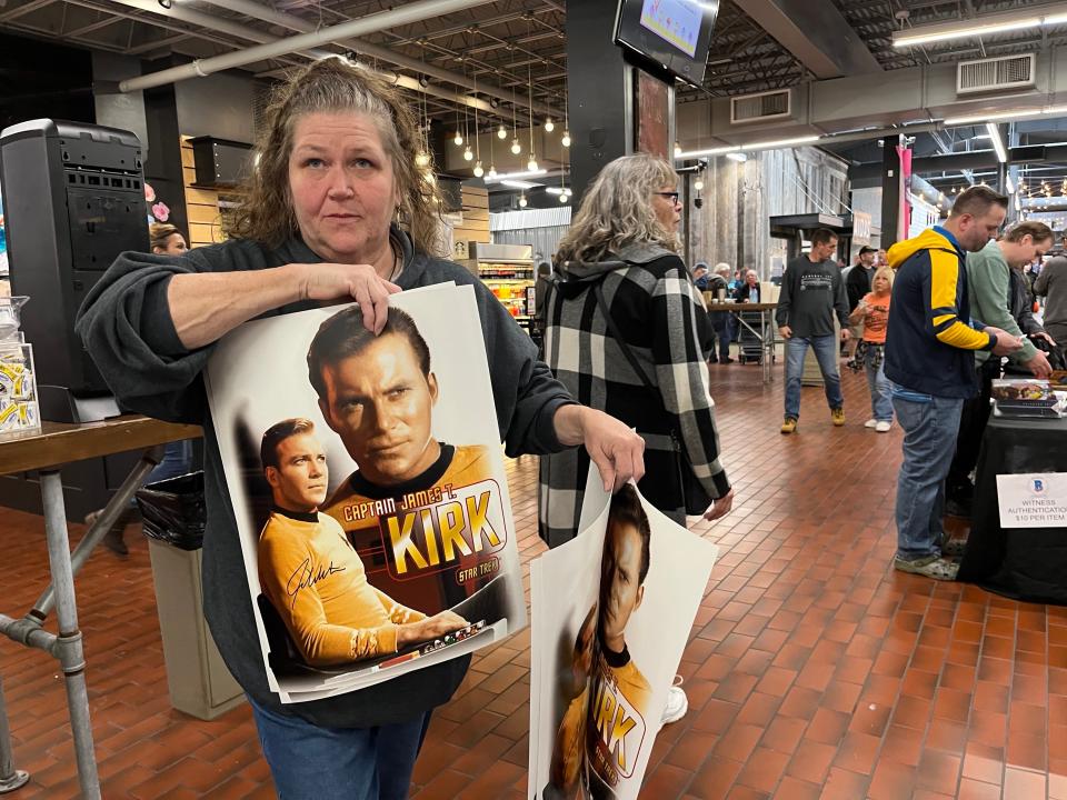 Stacy Klotz of Massillon shows her poster of Star Trek's Captain James T. Kirk that she got the actor who played him, William Shatner, to autograph at Hartville MarketPlace Saturday.