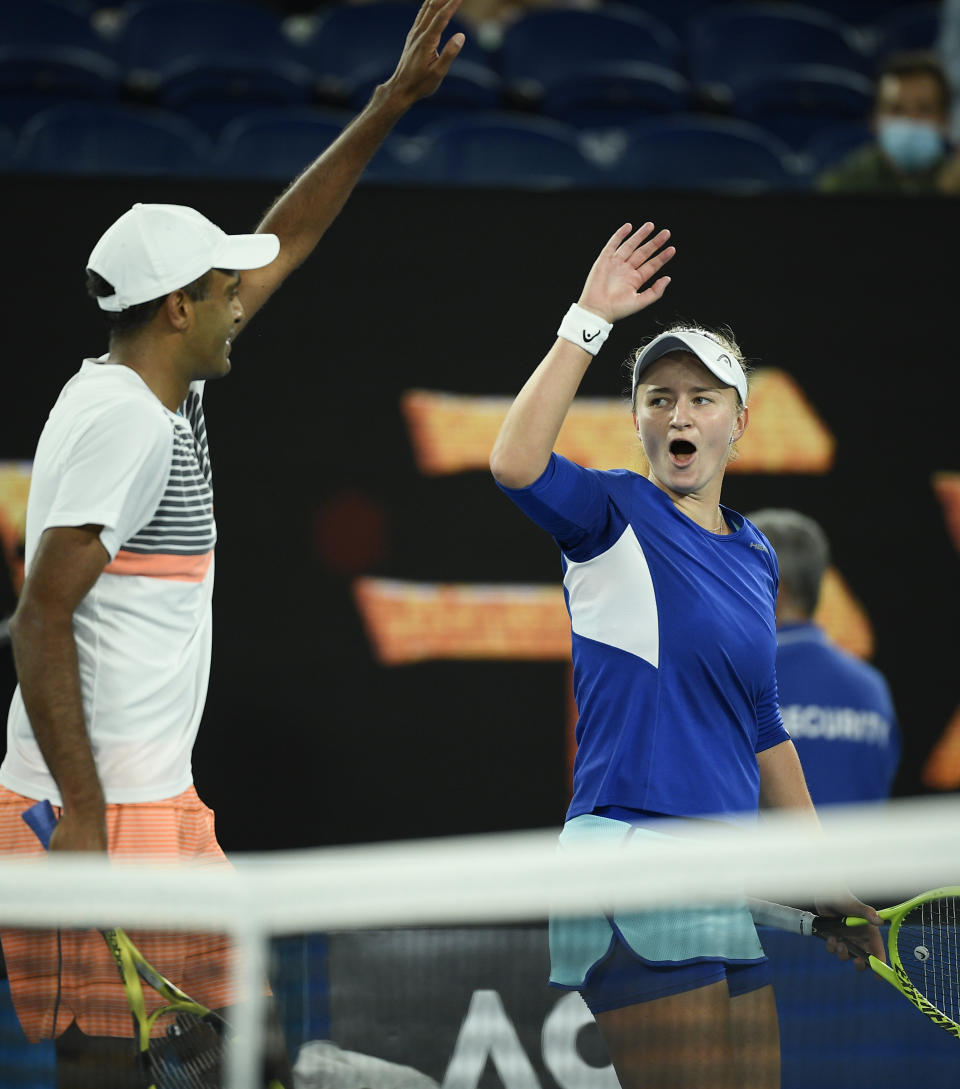 Rajeev Ram of the US and Barbora Krejcikova of the Czech Republic celebrate after defeating Australia's Samantha Stosur and Matthew Ebden in the mixed doubles final at the Australian Open tennis championship in Melbourne, Australia, Saturday, Feb. 20, 2021.(AP Photo/Andy Brownbill)