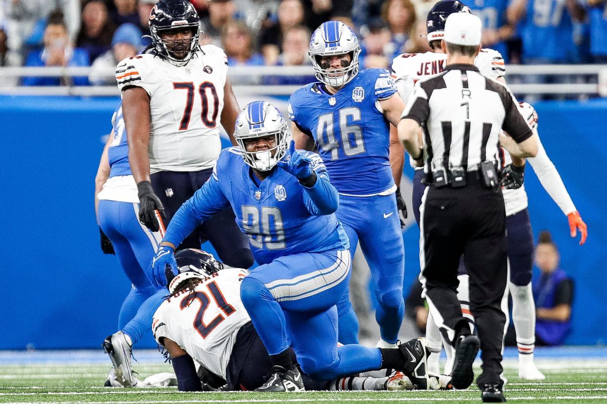 Detroit Lions defender Quinton Bohanna celebrates a tackle against Chicago Bears running back D'Onta Foreman during the first half at Ford Field in Detroit on Sunday, Nov. 19, 2023.