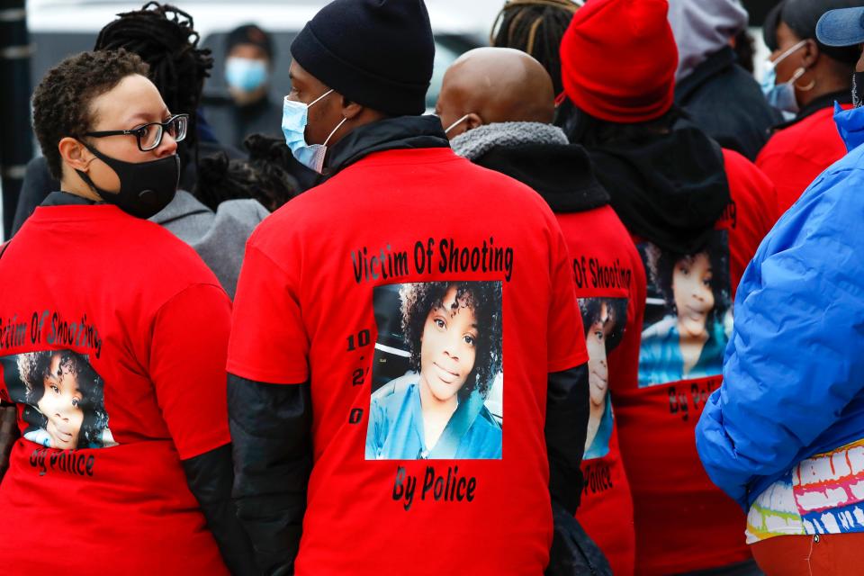 The family of Tafara Williams, pictured on the back of several t-shirts, who was wounded by a Waukegan police officer, gather outside of Waukegan City Hall in Waukegan, Ill., on Tuesday, Oct. 27, 2020.