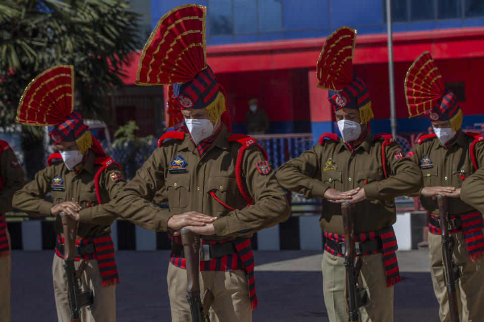 Indian police officers salute as they pay respect to their colleague Rameez Ahmad during a wreath laying ceremony in Srinagar, Indian controlled Kashmir, Thursday, April 1, 2021. Gunmen in disputed Kashmir on Thursday killed a policeman as they tried to storm the residence of a politician of India's ruling party, police said. (AP Photo/ Dar Yasin)