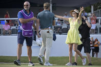 Sam Burns, center, is congratulated by his wife, Caroline Campbell, right, after putting on the 18th green to win the Valspar Championship golf tournament, Sunday, May 2, 2021, in Palm Harbor, Fla. (AP Photo/Phelan M. Ebenhack)