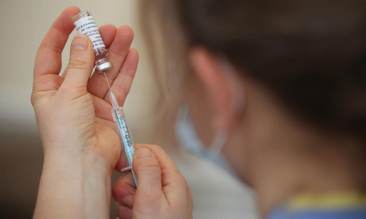 <span>A nurse preparing a Covid-19 vaccine. Some groups at increased risk from Covid are no longer eligible for jabs on the NHS.</span><span>Photograph: Nick Potts/PA</span>